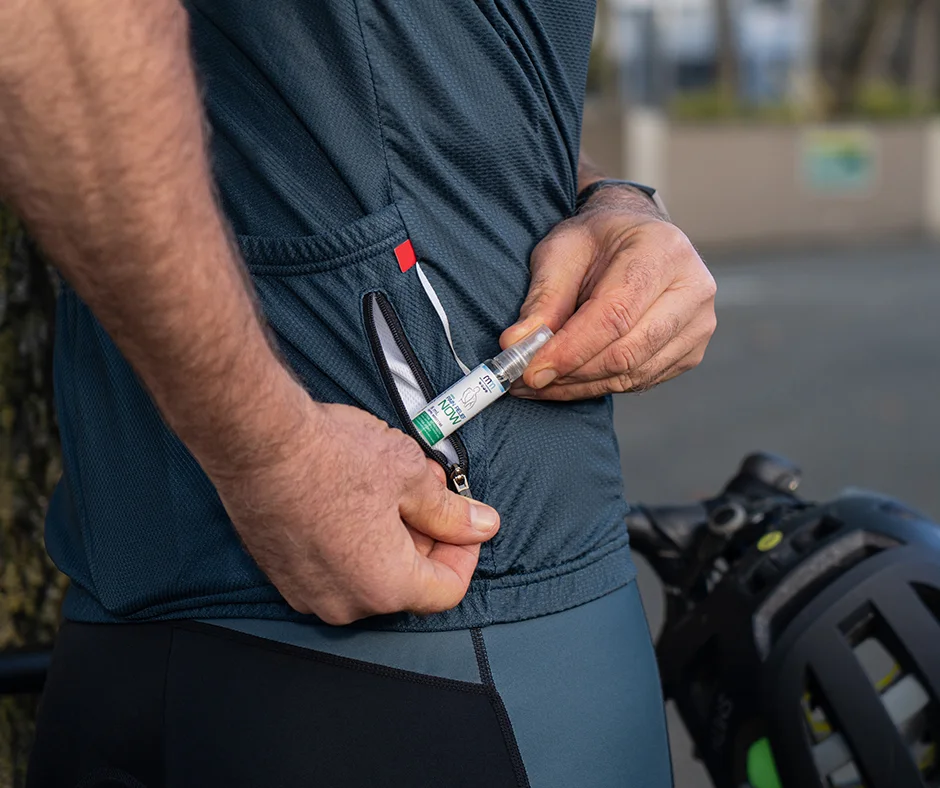 Man putting the pain relief now spray in pocket